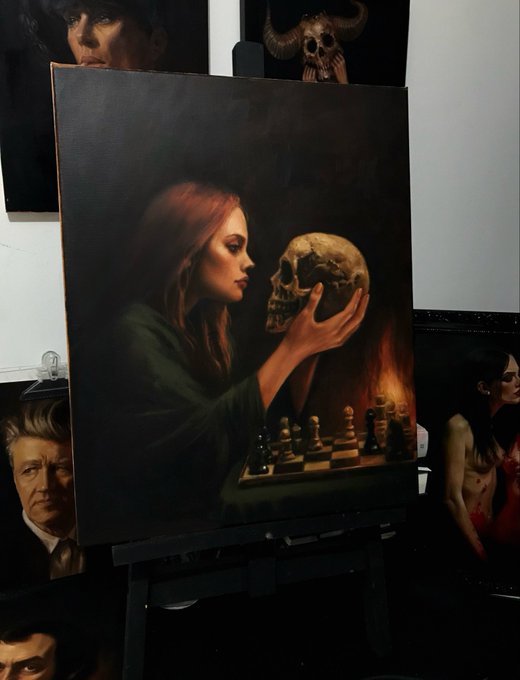 A dark surrealist painting on an easel depicting a woman holding a human skull above a chessboard with burning candles, surrounded by other portraits in the background.