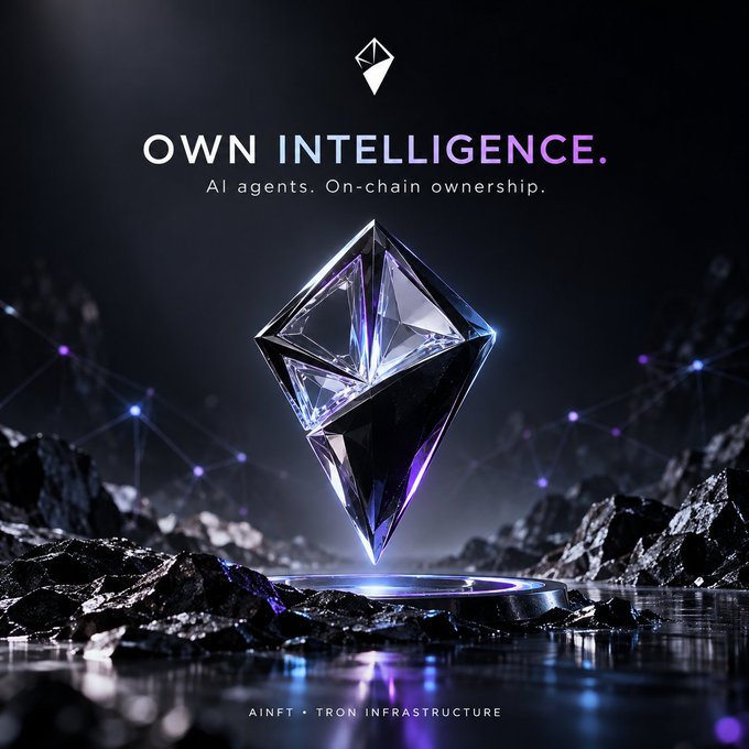 A promotional graphic featuring a glowing Ethereum diamond logo on a dark, rocky surface with the text 'OWN INTELLIGENCE. AI agents. On-chain ownership.' and 'AINFT • TRON INFRASTRUCTURE' at the bottom.