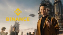 A man in a tan jacket stands on a city street, smiling and gesturing with excitement, while the Binance logo and wordmark appear overlaid on the left side of the image. The Binance branding pairs with the enthusiastic "WOOOOOOOOOOOOO" caption, suggesting a joyful crypto trading moment.