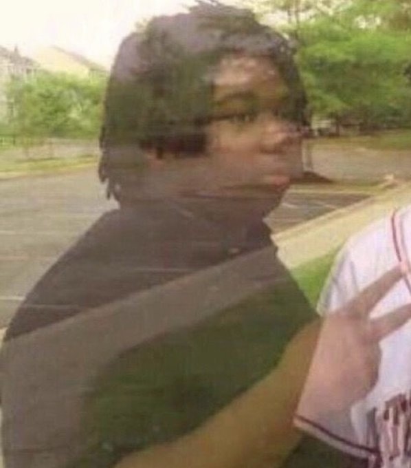 A man wearing glasses and a seatbelt looks sideways with a concerned expression, next to someone in a red shirt, as if reacting to disappointing news — fitting the post's sentiment about Roobet teasing a potential album collaboration between TimTheTatman and Nadeshot.