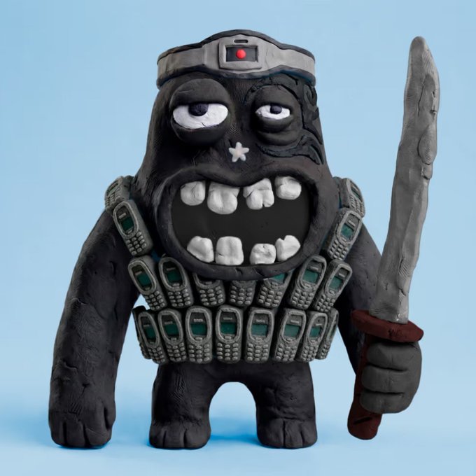 A clay figurine of a grinning monkey-like creature wearing a GoPro-style head camera and bandolier, holding a stone sword against a light blue background.