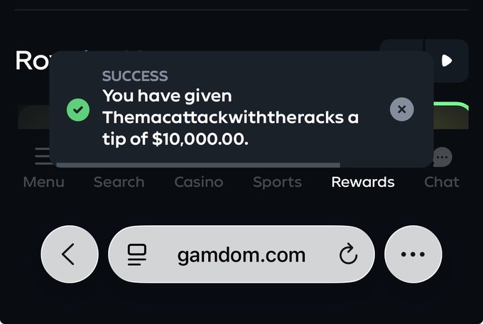 A screenshot of gamdom.com displays a success notification confirming a $10,000.00 tip has been given to "Themacattackwiththeracks," illustrating the user's generous contribution on top of rakeback and leaderboard earnings.