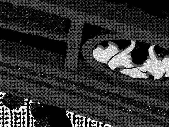 A grainy, high-contrast black and white image showing a crumpled fabric or garment behind what appears to be a textured railing or grate.
