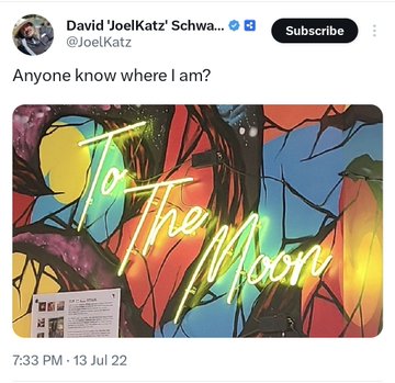 A vibrant neon "To The Moon" sign glows against a colorful stained-glass-style background, posted by David 'JoelKatz' Schwae with the caption "Anyone know where I am?" alongside "Moon Time #XRP," suggesting a celebratory crypto milestone as the XRP token heads to the moon.