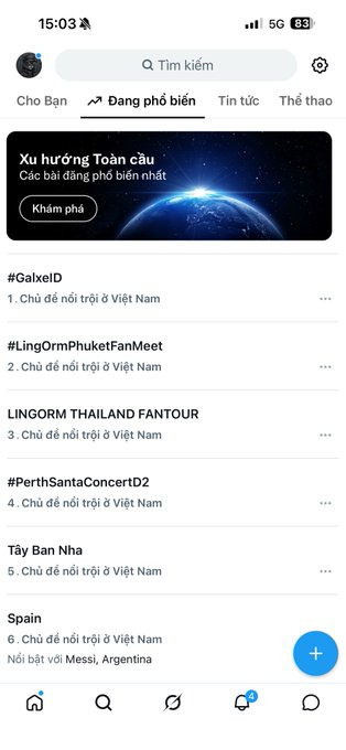 A Vietnamese mobile app screenshot showing trending topics on X (Twitter) including #GalxeID, #LingOrmPhuketFanMeet, #PerthSantaConcertD2, and 'Spain' related to a Messi celebration.