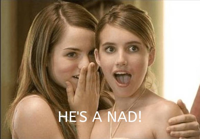 The image features two young women with long hair standing close together, one of whom has her mouth open as if she's speaking or making a funny face. The text "He's A Nader!" appears below them, which seems to be a reference to a movie or show they might have watched together.