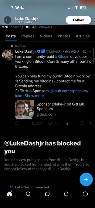 Twitter/X profile page of Luke Dashjr (@LukeDashjr) with 159.7K posts and 103.4K followers, showing a pinned post about Bitcoin development, along with a notification indicating the user has blocked the viewer.