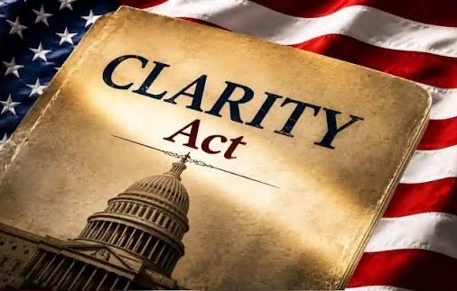 The image displays a weathered book or document titled "CLARITY Act" resting on an American flag, with the U.S. Capitol dome featured at the bottom. This visual complements the post's message about SEC Commissioner Hester Peirce's optimistic outlook on the CLARITY Act potentially passing soon this summer, using patriotic imagery to underscore the legislation's significance to U.S. financial regulation.