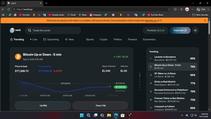 The image shows a screenshot of the World (world.xyz) prediction market platform featuring a Bitcoin Up or Down 5-minute prediction market with a current price of $77,209.72, where betting options show "Up-806" and "Down-246". The banner at the top states "Stimmies are paused until rollout is complete, will resume shortly," which directly addresses the user's concern about claiming rewards—explaining why they weren't able to claim any stimmies yesterday.