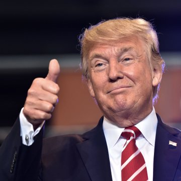 President Trump gives a thumbs-up in this image, relating to his statement about placing cryptocurrency holdings into a blind trust under the Clarity Act.