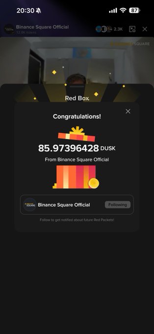 A Binance mobile app screenshot showing a 'Red Box' reward notification with 85.97396428 DUSK tokens from Binance Square Official.