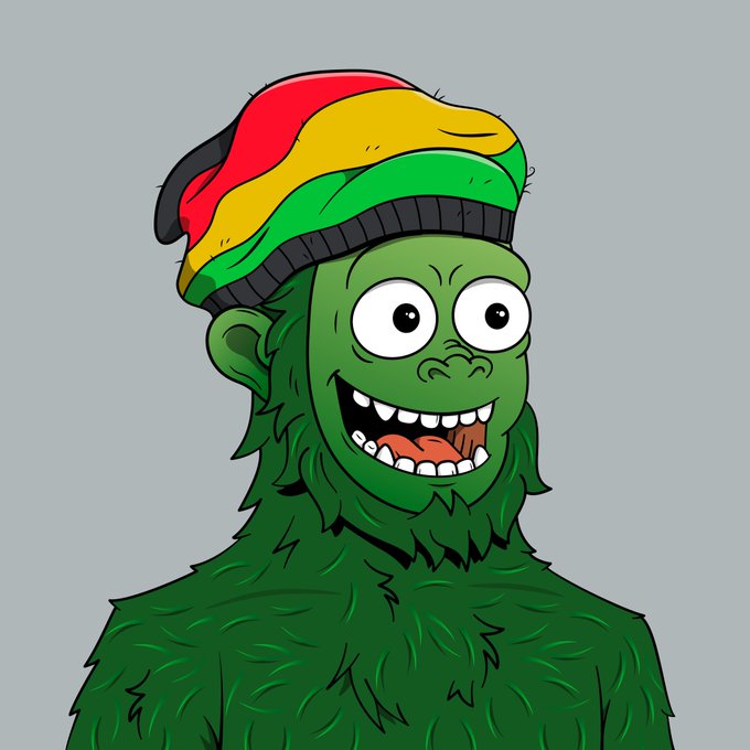 A cartoon illustration of a green furry creature with a wide, toothy grin, wearing a red, yellow, and green beanie.