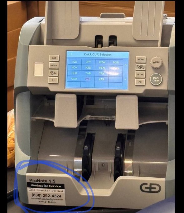 A Giesecke + Devrient (G+D) ProNote 1.5 currency counting machine is displayed with a "Quick CUR Selection" menu featuring Iraqi Dinar (IQD) as a selectable currency option, along with JPY, KRW, MXN, NOK, NZD, PEN, SEK, THB, TRY, USD, VND, and ZAR. A contact sticker shows the service provider at (888) 292-4324 and www.gd-de.com, supporting the post's claim about G+D's connection to IQD currency equipment.
