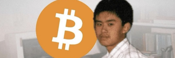 A young man in a white shirt looks at the camera beside a large Bitcoin logo, with a blurred bookshelf and computer monitor in the background. The image appears to reference the anonymous founder of Bitcoin, Satoshi Nakamoto, humorously paired with the post's promotion of the "$APARTMENT" meme coin on the BNB chain.