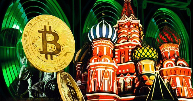 A large gold Bitcoin coin stands in front of an illuminated Saint Basil's Cathedral in Moscow, symbolizing the intersection of cryptocurrency and Russia. The image visually reinforces the post about Russia's ban on crypto mining in Moscow until 2032, highlighting the regional impact on the country's crypto industry.