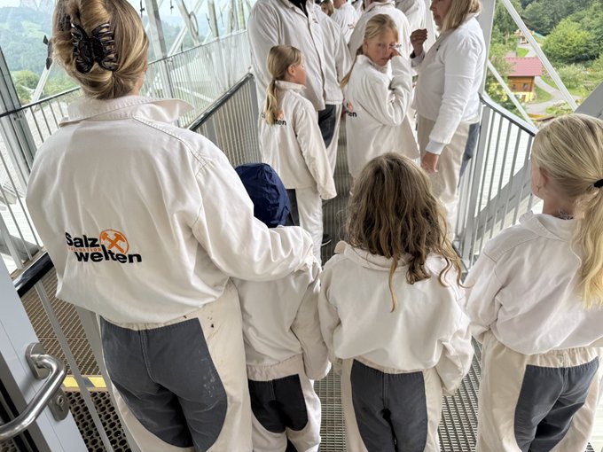 A group of children wearing white coats with "Salz Welten" logos gather on a metal walkway, likely on a tour of the Austrian salt mine attraction. The post's playful reference to "Salz Welten" (German for "Salt Worlds") connects the mine tour imagery to bullish sentiment on ORE, suggesting a tongue-in-cheek metaphor about mining enthusiasm.