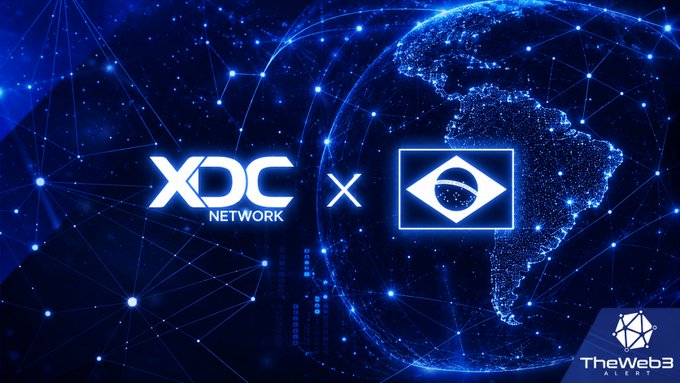 The image displays a partnership graphic featuring the "XDC NETWORK" logo alongside another logo, set against a backdrop of a glowing blue digital globe highlighting South America and network connection nodes, with a "TheWeb3 Alert" watermark in the corner. This visual reinforces the post's theme of XDC Network's expanding presence and infrastructure developments in Brazil, particularly within the RWA (Real World Assets) and government verification sectors.