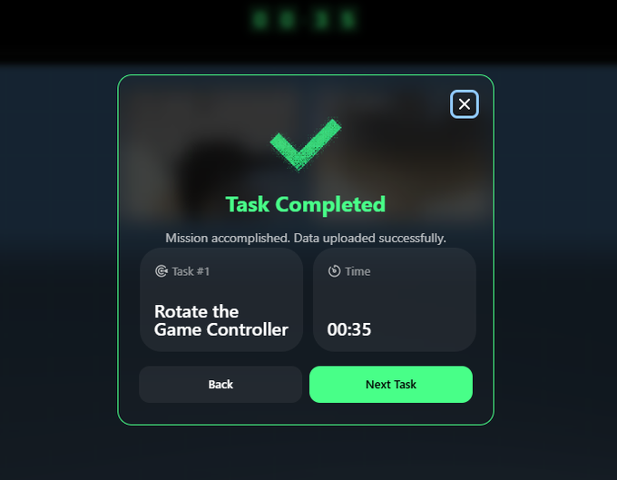 A 'Task Completed' success modal on a dark interface with green accents, showing the completed task 'Rotate the Game Controller' was finished in 00:35, with options to go back or proceed to the next task.