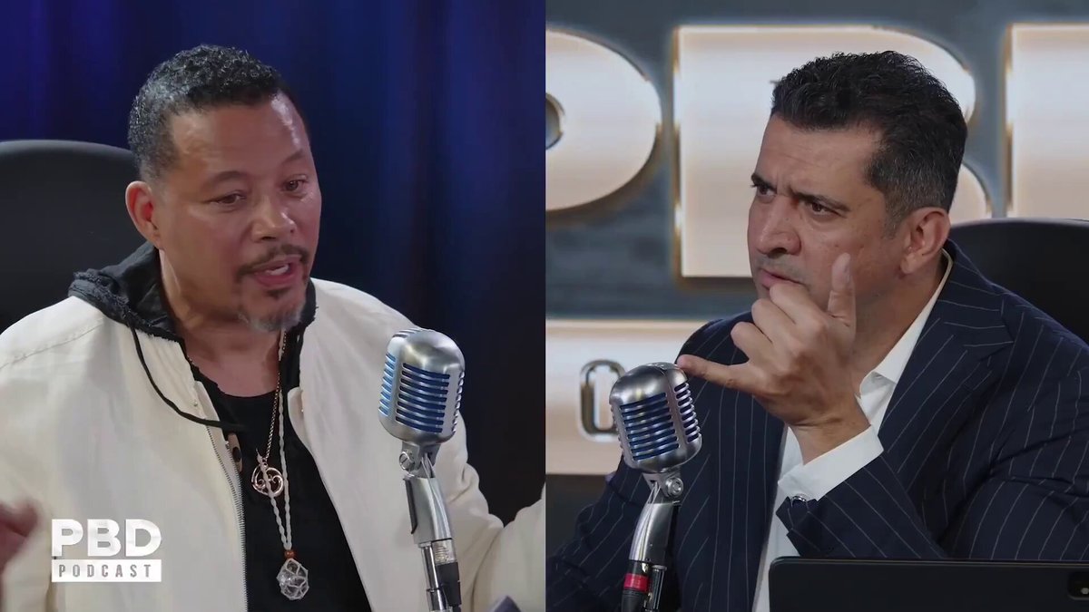 The image shows two men sitting behind microphones at a table, likely participating in an interview or discussion about Bitcoin. One man has his hand raised while talking, suggesting he may be expressing his opinion or sharing information related to Bitcoin. The other man is wearing a suit and tie, indicating that they are discussing a topic of professional interest. The post by Terrence Howard warns against Bitcoin, implying that it might face challenges in the future.