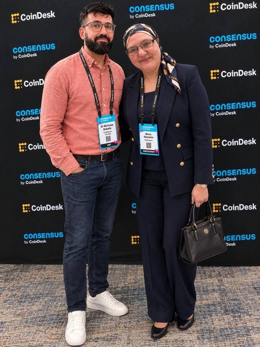 Two attendees, Qassim and Mariam from the Pi Network Community Team, pose together at Consensus by CoinDesk, with their name badges visible against the event's branded backdrop. The image accompanies a post inviting the Pi Core Team to engage with the community, likely highlighting the team's presence at the prominent blockchain conference.