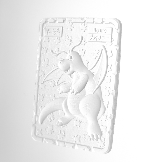 A monochromatic white embossed card featuring a raised Dragonite design with Japanese text "ポリゴン" (Polygon) and "ポケモン" (Pokemon) visible in the upper corners, shown as a 3D render that previews how the physical printed card will appear when minted.