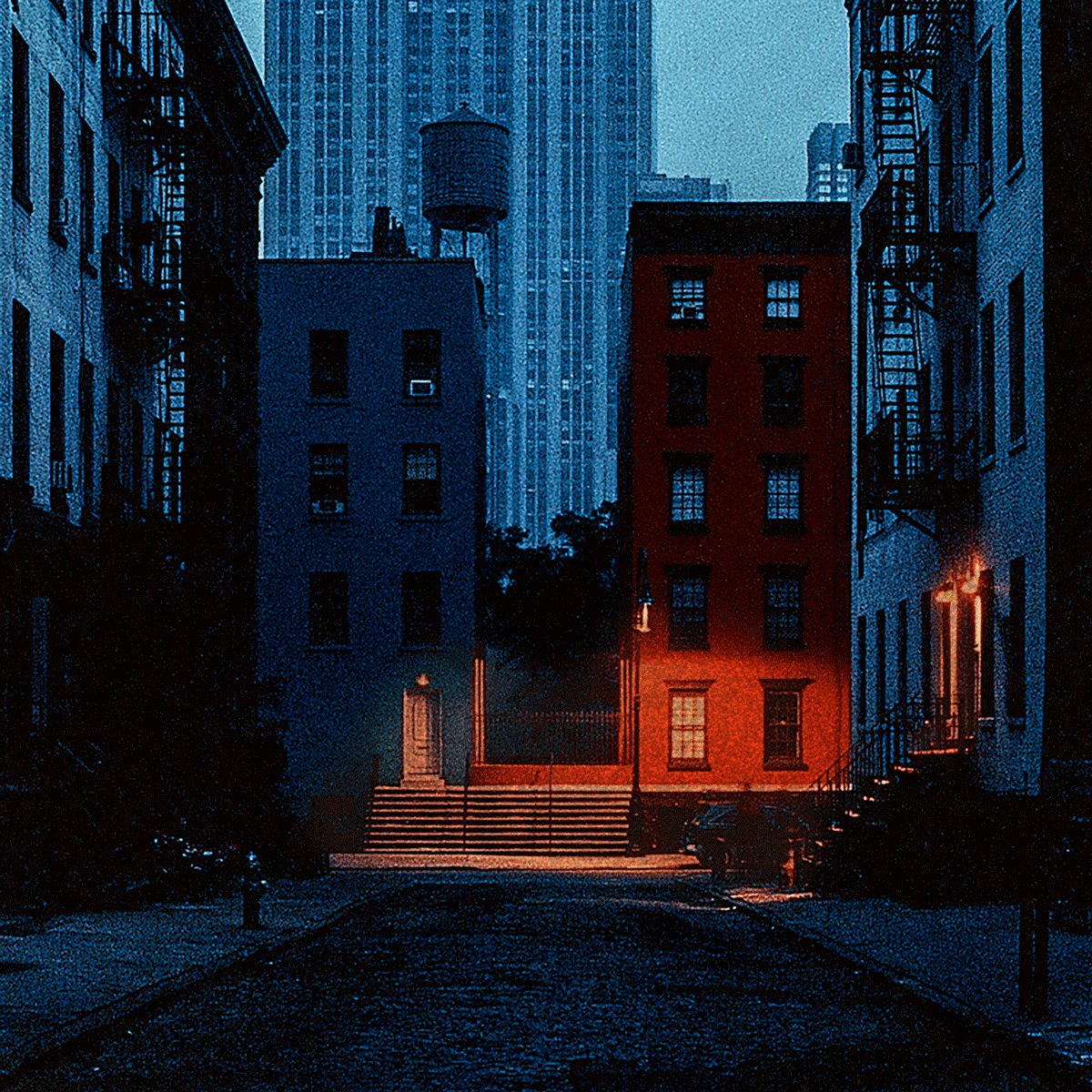 The image shows a city street at night with tall buildings, including one that appears to be a water tower. The scene has a dark blue color scheme, giving it an urban atmosphere. There are two people walking down the sidewalk near some stairs, possibly heading towards their workplace or other destination. A car is parked on the side of the road, and there's a fire escape in front of one of the buildings. The image also contains text that reads "Good morning, finally FRIDAY. Wish you a good and EASY day at your works my friends. take this magical potion, and run to create some art."