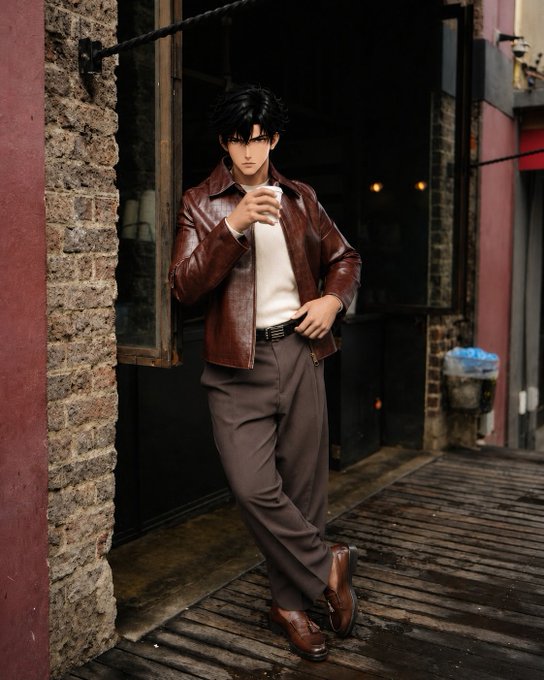 A photograph of a male doll or action figure posed in an alleyway, wearing a brown leather jacket, white sweater, gray pants, and brown loafers, styled to resemble an anime character.