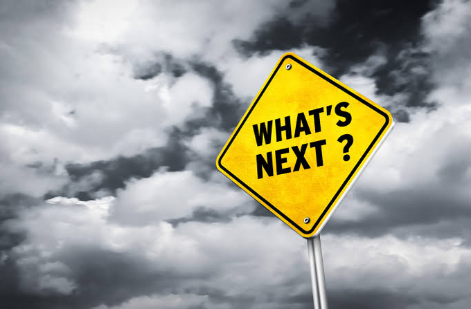 A yellow road sign reading "WHAT'S NEXT?" stands against a dramatic cloudy sky, symbolizing uncertainty about future developments in Tether wallet blocking by cryptocurrency exchanges. The image visually reinforces the post's warning that the main wave of blocked wallets and subsequent financial impact has yet to unfold.