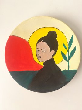 A circular pin or badge featuring a stylized painted portrait of a woman with her hair in a bun, set against a background with a red semi-circle, yellow halo, and a green plant.