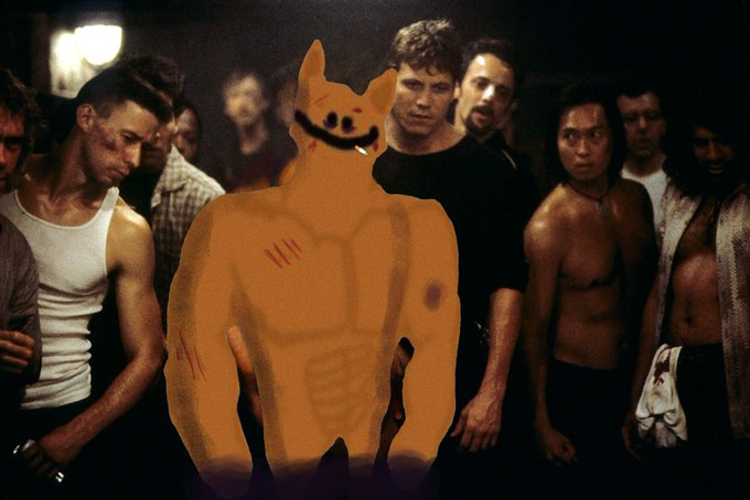 A scene from the movie Fight Club showing Tyler Durden leading a group of shirtless men, but his face has been crudely drawn over with an orange cat meme face.