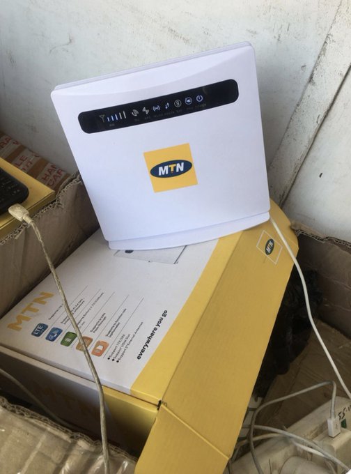 A white MTN-branded wireless router sitting atop its yellow packaging box, which reads 'everywhere you go' and 'MTN'.
