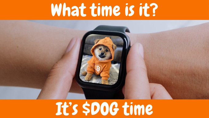 Smartwatch displaying a Shiba Inu dog wearing an orange hoodie, with orange banner text reading 'What time is it?' at the top and 'It's $DOG time' at the bottom.