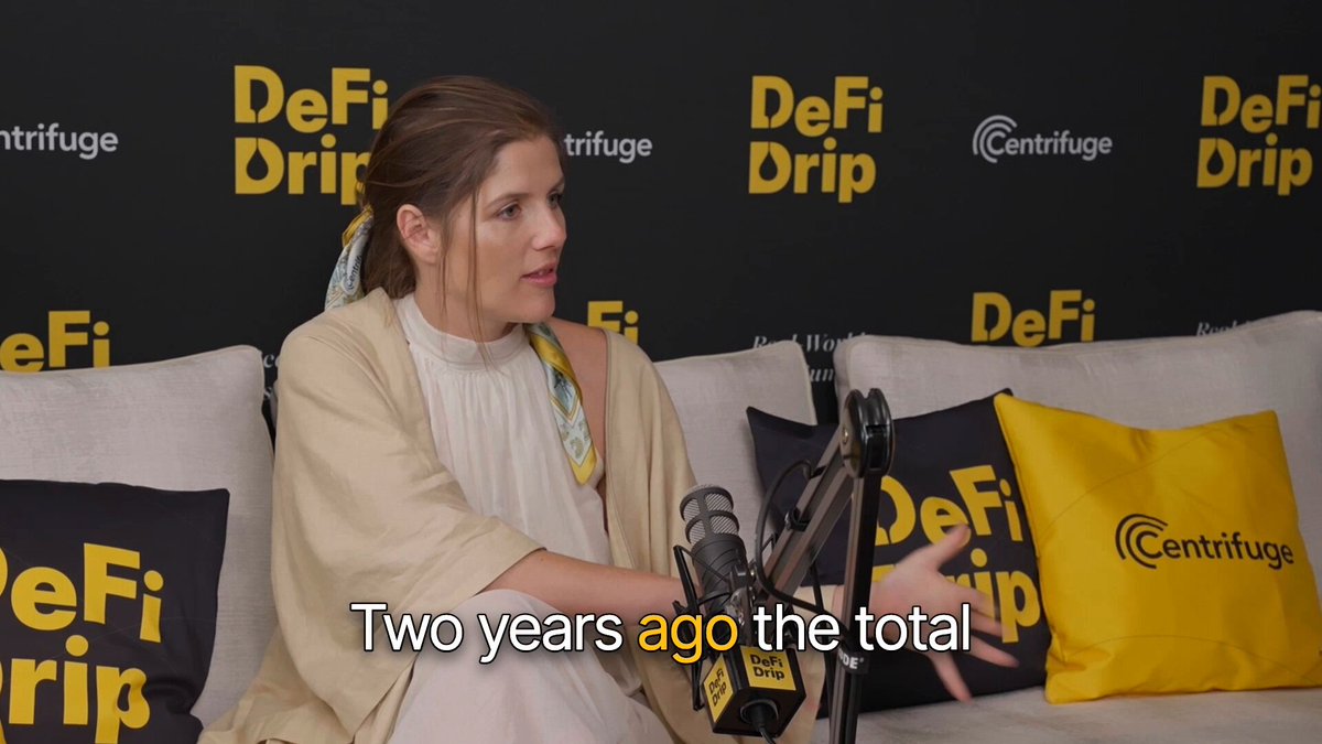 The image features a woman sitting on a couch with her hands outstretched towards the camera. The background of the image shows a black wall with yellow text, which reads "Two years ago the total", indicating that this photo was taken two years ago. The caption below the image provides information about DeFi and how it can be used to create tokens for various purposes such as plugging into DeFi projects or serving as collateral in structured products.