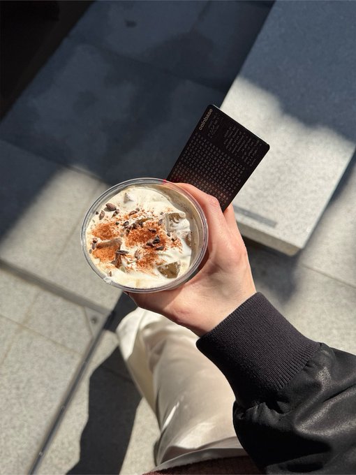 The image shows a person holding a cup of ice cream with toppings, possibly a sundae or milkshake, while sitting down. The person's hand is visible near the bottom right corner of the photo. The accompanying text on the post asks about the user's recent activities on their Coinbase account and inquires if they have been up to anything interesting recently.

The image does not provide any specific information about the user's Coinbase account or recent activities, but it does capture a moment where the person is enjoying a dessert while browsing through their account details.