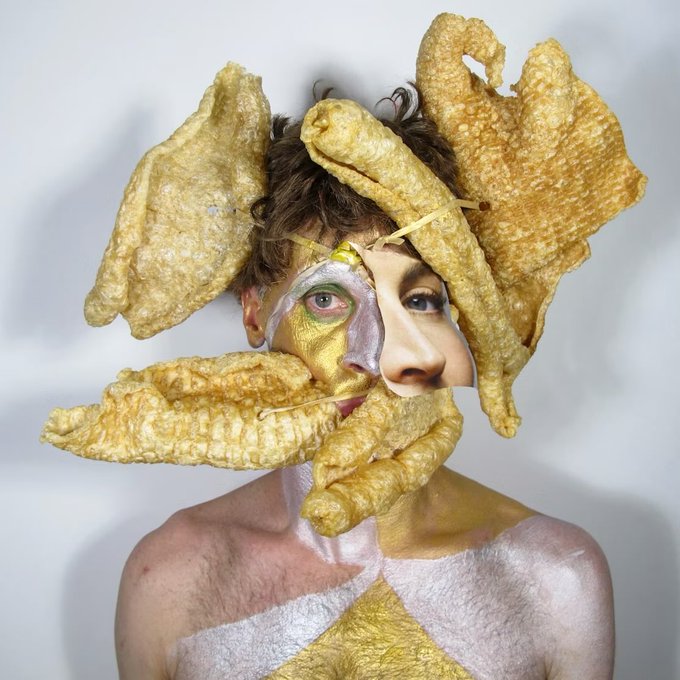 An avant-garde photo featuring a person with makeup and what appears to be fried pork rinds or similar textured food items arranged around their head and face.
