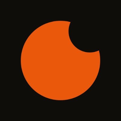 A simple graphic displays a large orange circle with a wedge cut out of the top right side, set against a solid black background.