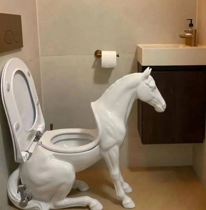 A novelty toilet shaped like a white horse is installed in a bathroom, with the seat and lid open and the horse's head positioned near the sink.