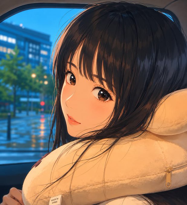 An anime-style illustration of a girl with dark hair hugging a cream-colored pillow, gazing out a window at a city street at dusk.