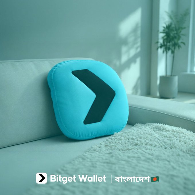 A teal cushion featuring the Bitget Wallet logo rests on a light-colored couch beside a sunlit window, with "Bitget Wallet | বাংলাদেস" text displayed at the bottom. The cozy, personalized living space complements the post's Bengali message, "Your space, your style, your Bitget Wallet. Good night," by visually tying the brand to a comfortable, stylish nighttime setting.