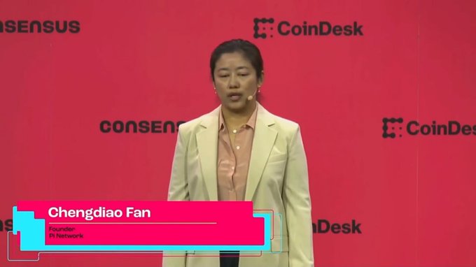 A woman identified as Pi Network founder Chengdiao Fan speaks at the CoinDesk Consensus Miami conference, standing against a red backdrop displaying the event's logos.