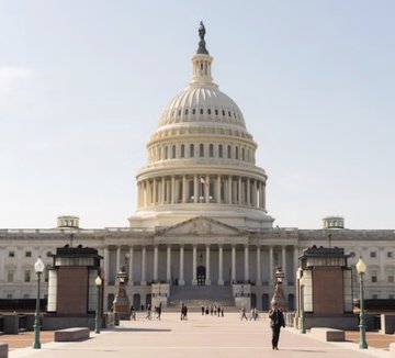 The U.S. Capitol Building stands prominently under a clear sky, serving as the iconic backdrop to legislative activity. This image relates to the post about Senate Democrats preparing a counteroffer to the Republicans' Clarity Act ahead of a scheduled cloture vote at 2:15 p.m. ET on Tuesday.