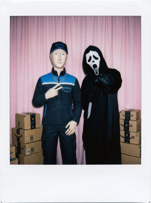 A Polaroid-style photo showing a mannequin dressed in a 'prime' delivery uniform standing next to a person in a Ghostface (Scream) costume holding a knife, with stacks of Amazon boxes beside them against a pink curtain.
