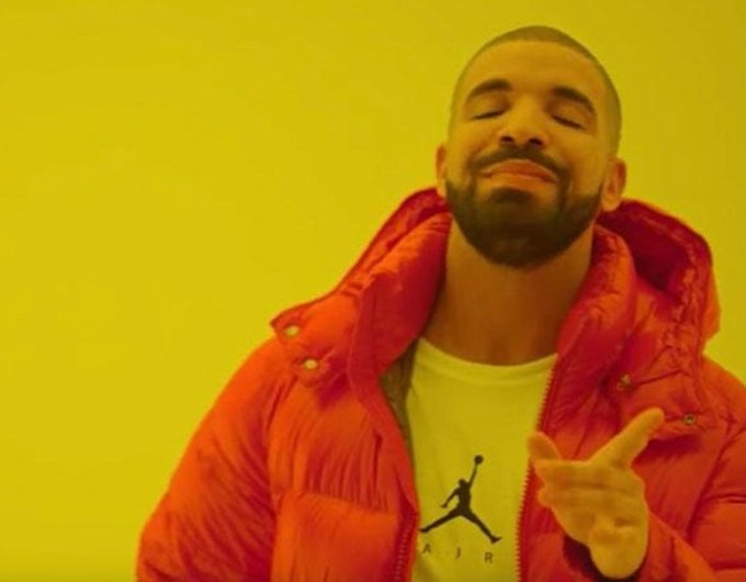 A meme image of rapper Drake wearing an orange puffer jacket over a yellow Air Jordan t-shirt, smiling with eyes closed against a bright yellow background.