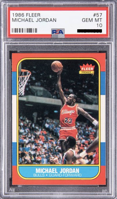 A PSA-graded 1986 Fleer #57 Michael Jordan basketball card, encapsulated in a PSA slab with a "GEM MT 10" grade, serves as the underlying real-world asset backing the gMJ tokenized collectible. The card depicts Jordan in his red Chicago Bulls #23 uniform performing a layup, with the PSA label confirming the card's premium condition that supports its $414,800 valuation referenced in the post.