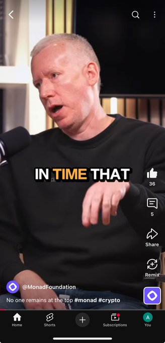 A video screenshot of a man speaking into a microphone with the text "IN TIME THAT" overlaid; the post is from @MonadFoundation and reads "No one remains at the top #monad #crypto".