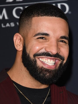 Drake smiles on a red carpet, pictured here in connection to his bold $1.5 million USDT bet on Argentina to win the World Cup final against Spain, placed through Stake at +245 odds with a potential $5.17 million payout.