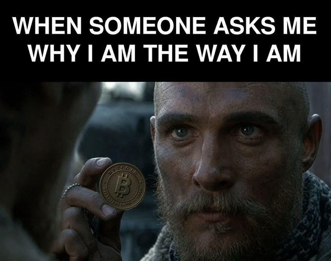 A meme featuring a man holding up a Bitcoin coin with the caption 'WHEN SOMEONE ASKS ME WHY I AM THE WAY I AM'.