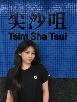 A portrait of a woman with long dark hair standing in front of a blue tiled wall displaying "Tsim Sha Tsui" in Chinese and English.