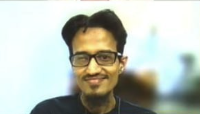 A close-up of a man with glasses and dark hair smiling at the camera, likely referencing @frankdegods' appearance at an Arc-related meeting or conference.
