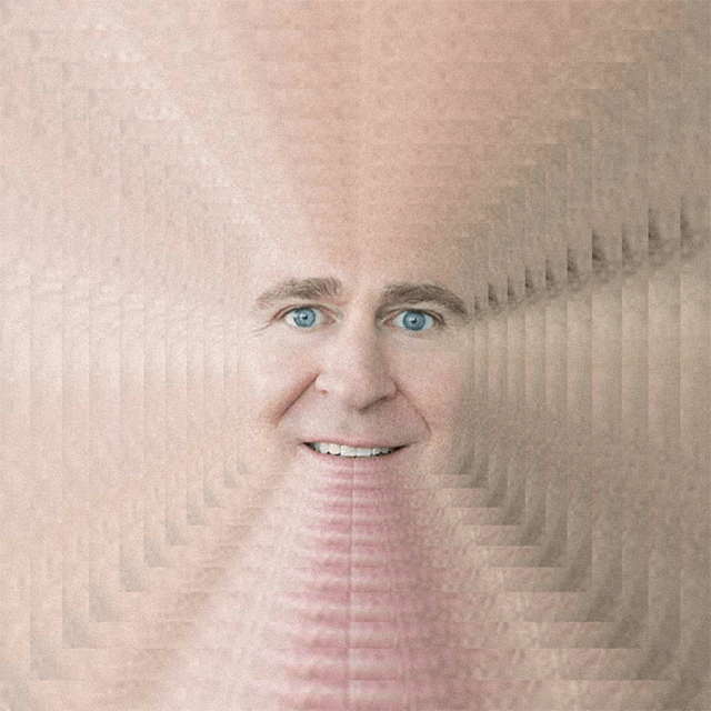 The image features a man with blue eyes, smiling at the camera. He appears to be wearing a fake face or a costume that makes him look like he's floating through space. The background of the photo consists of multiple lines of varying thicknesses, creating an interesting visual effect and making it difficult to discern any specific details about the image. The caption "Kenny... Kenny... Why do you rehypothecate GME?" is likely a reference to the popular TV show "The Office" or another similar series that features characters with exaggerated facial features or costumes.